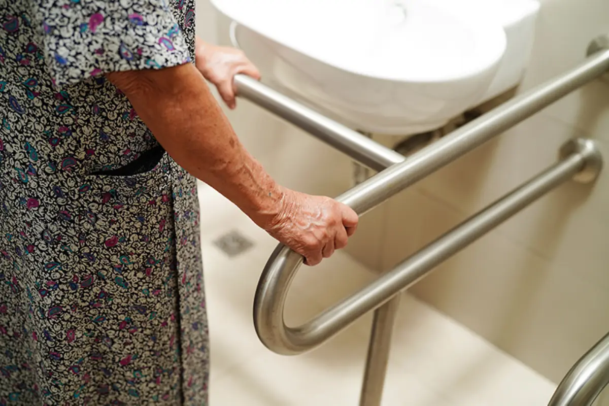 Senior holding bathroom safety handle